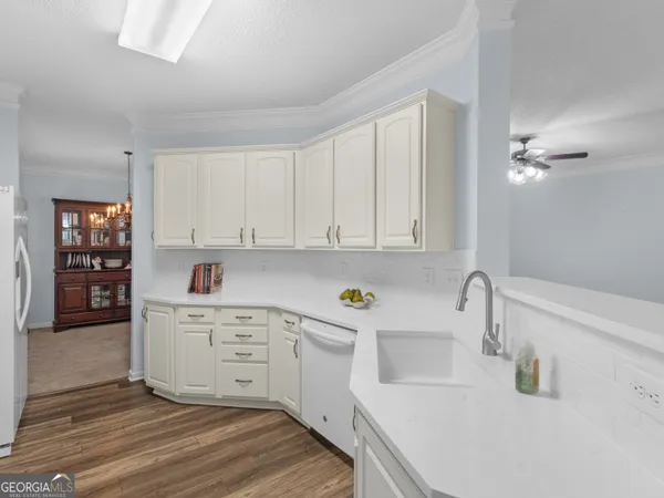 a kitchen with a sink cabinets and window