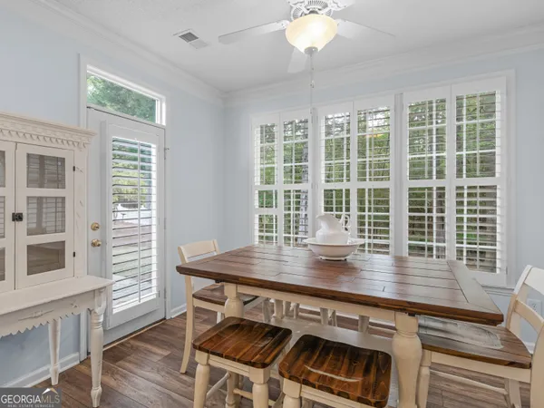 a view of a dining room with furniture window and wooden floor