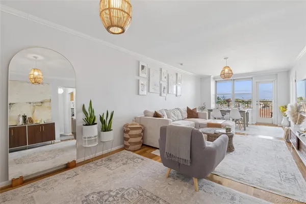 a living room with furniture a chandelier and a rug