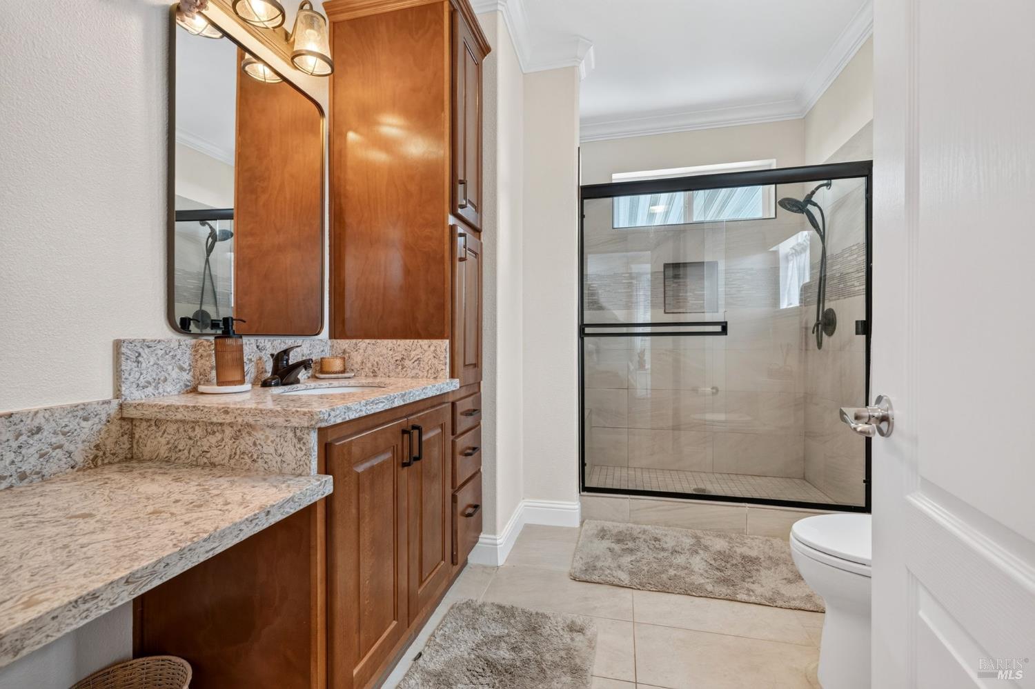 32 Springhill Court Santa Rosa, CA 95409 - Photo 17 of 46 Primary bathroom with slab counters, vanity, and spacious low entry shower
