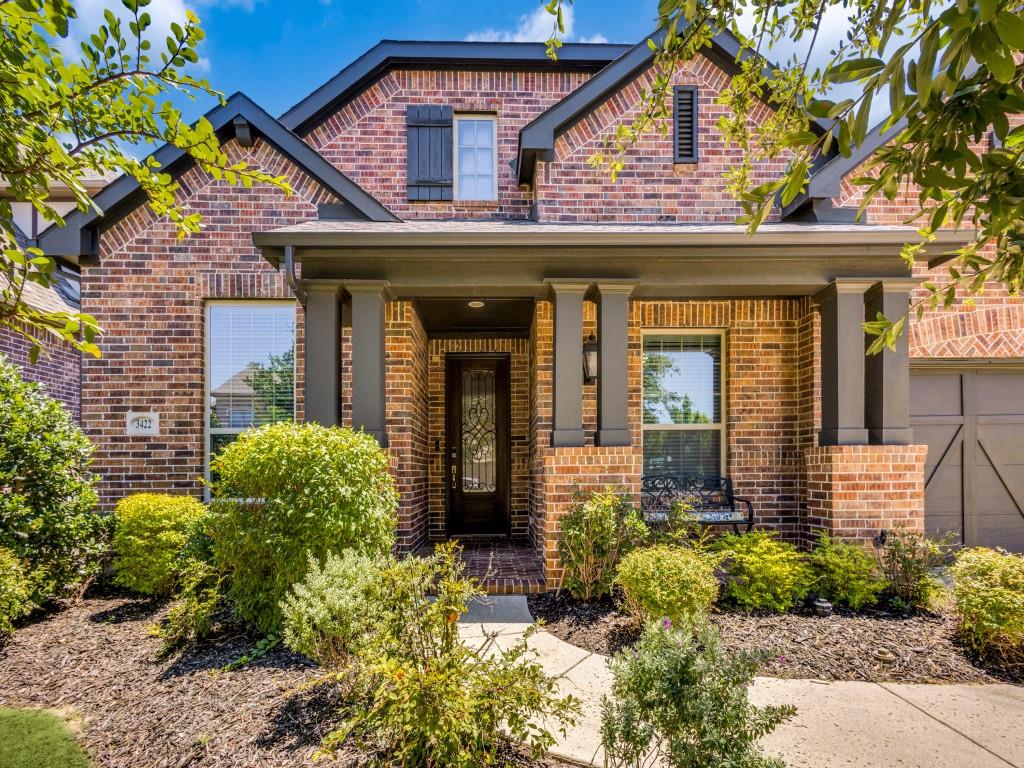 a view of a house with potted plants and a flower plants