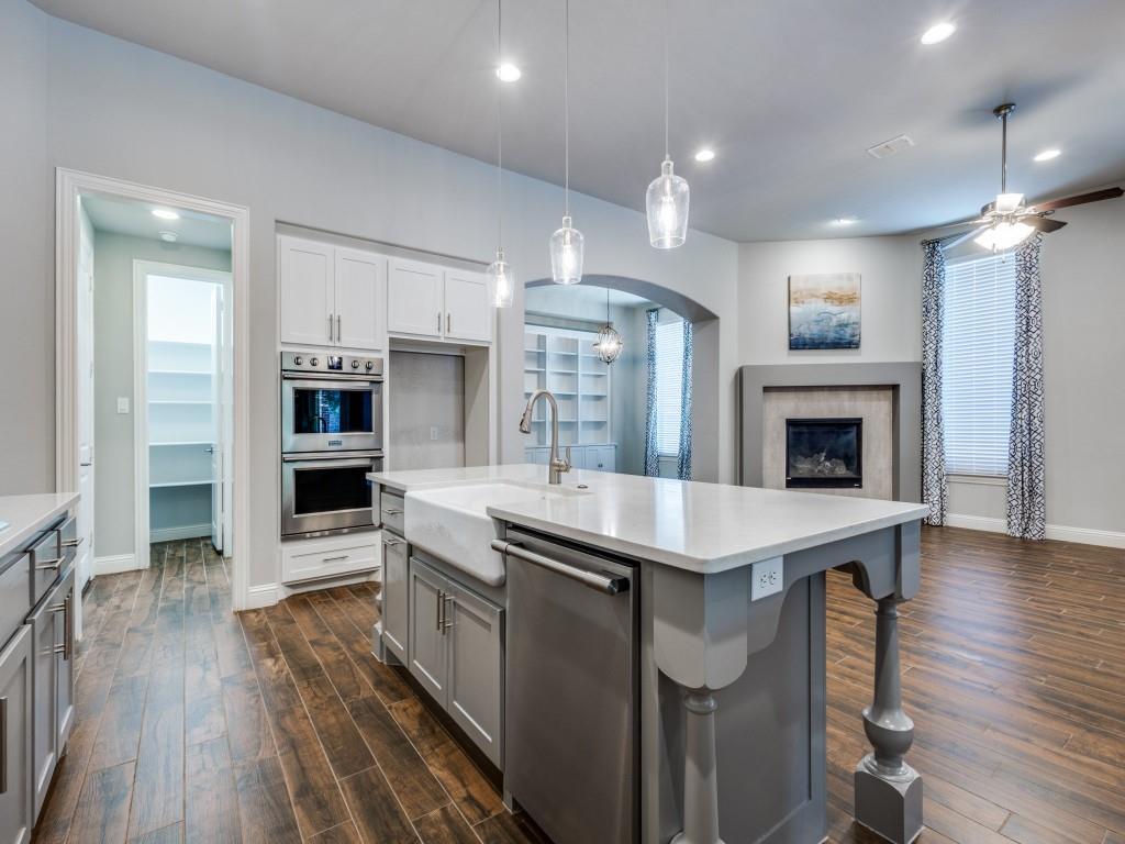 3422 Secretariat Place Celina, TX 75009 - Photo 12 of 28 a kitchen with kitchen island a stove a sink a oven and a refrigerator