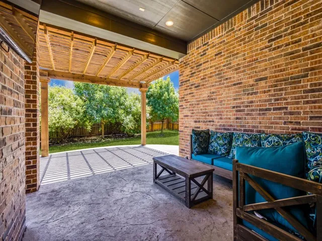 a view of a patio with a table and chairs