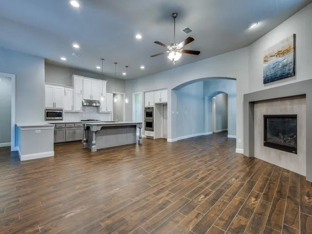 a view of kitchen and kitchen with a fireplace wooden floor