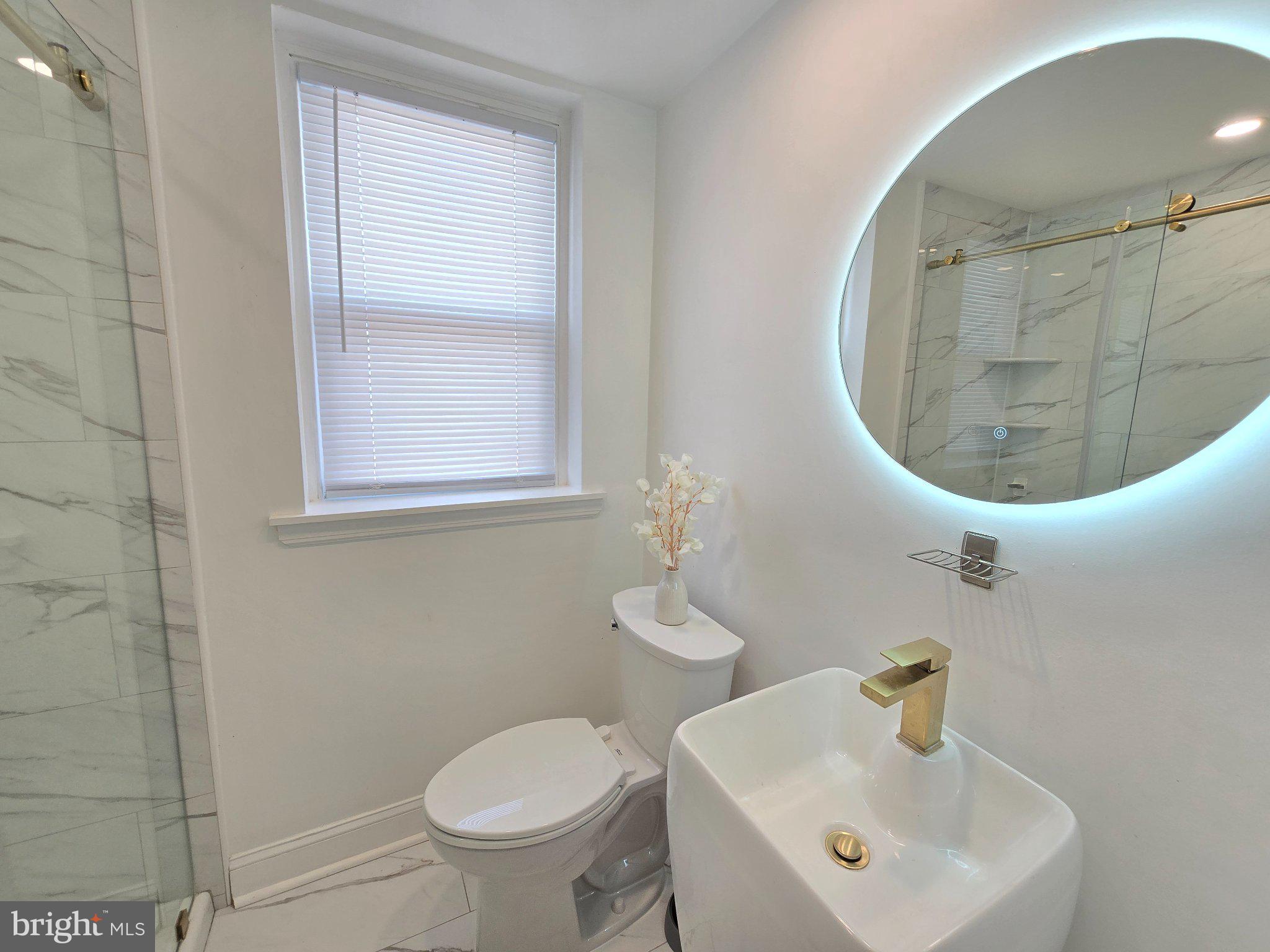 7638 Sherwood Road Philadelphia, PA 19151 - Photo 14 of 21 Sleek modern bathroom with elegant fixtures.