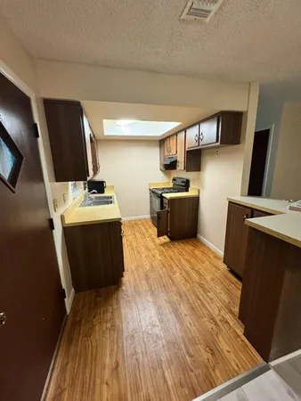 a kitchen with wooden floors and a sink