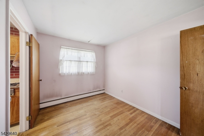 49 Heather Hills Drive Oak Ridge, NJ 07438 - Photo 18 of 34 an empty room with wooden floor and windows
