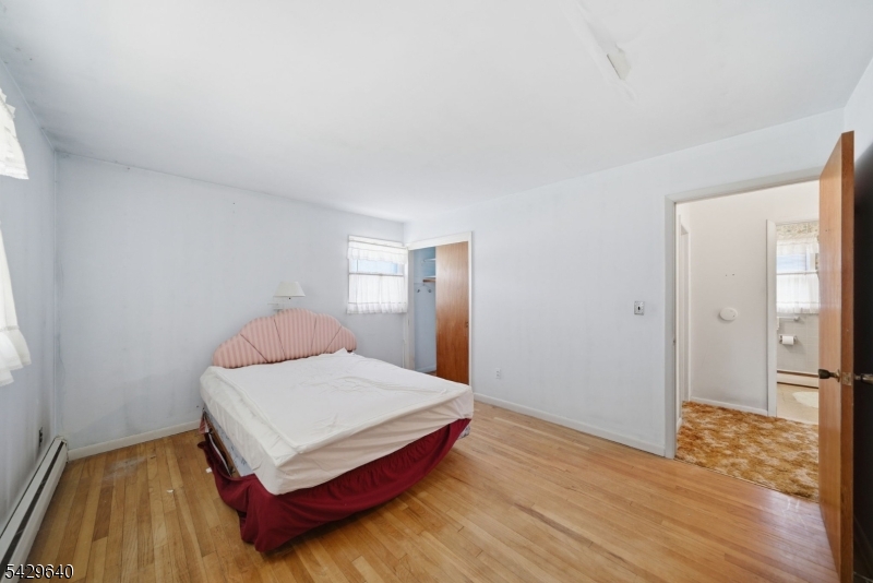 49 Heather Hills Drive Oak Ridge, NJ 07438 - Photo 19 of 34 a bedroom with a bed and wooden floor