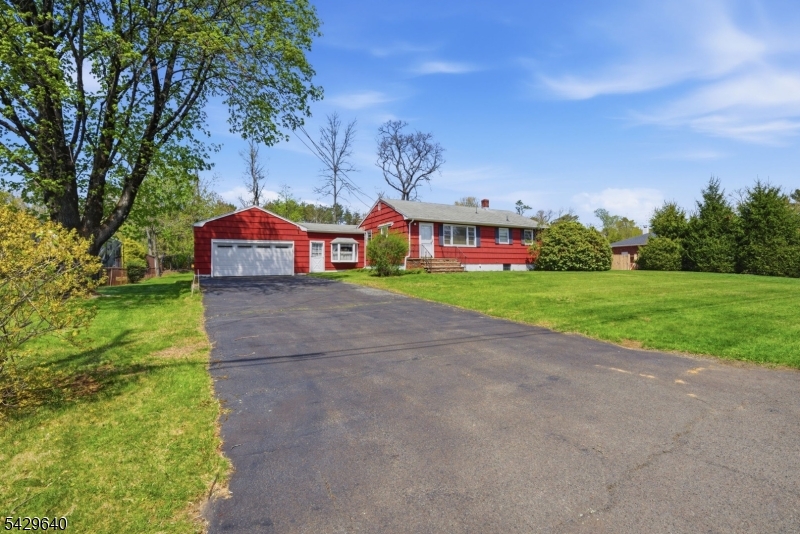 49 Heather Hills Drive Oak Ridge, NJ 07438 - Photo 2 of 34 a view of street with houses and trees in the background
