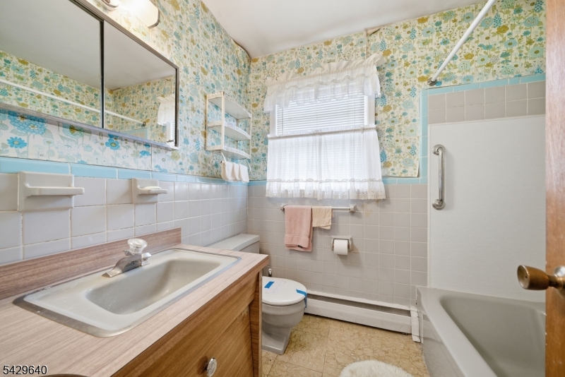 49 Heather Hills Drive Oak Ridge, NJ 07438 - Photo 23 of 34 a bathroom with a sink toilet and shower