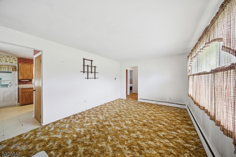 49 Heather Hills Drive Oak Ridge, NJ 07438 - Photo 4 of 34 a bedroom with a bed and a window