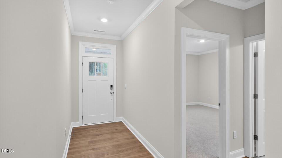 2204 Warbler Drive Apex, NC 27539 - Photo 2 of 32 a view of hallway with closet and a white door