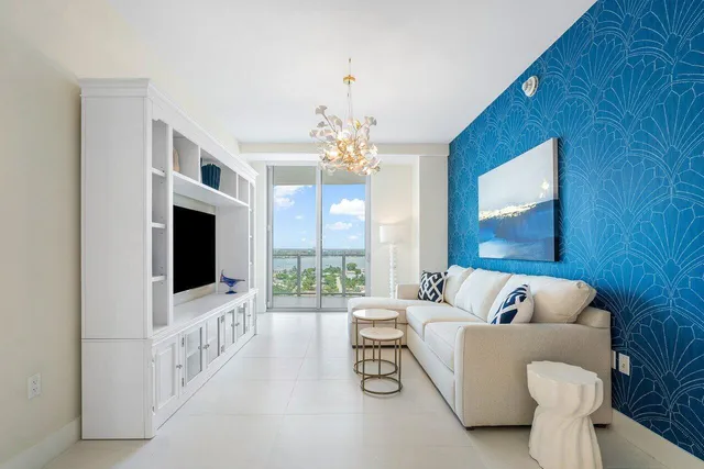 a spacious bedroom with a bed couch and a large window