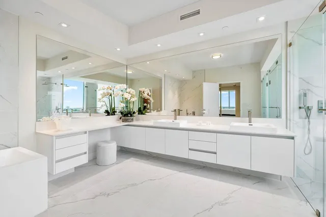 a bedroom with a large window and a bed