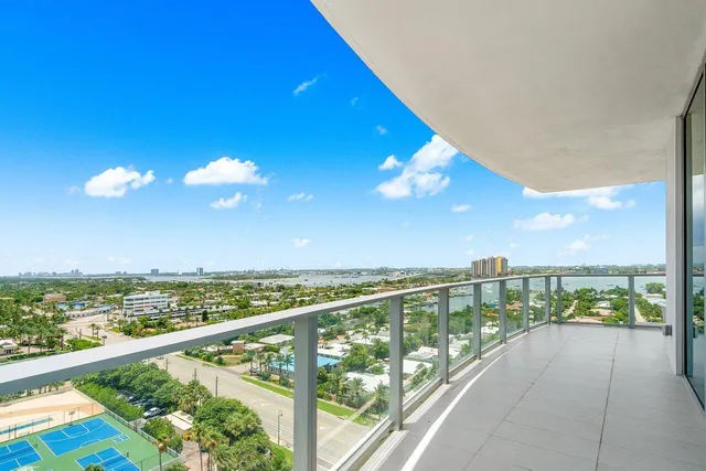 a living room with furniture a flat screen tv and floor to ceiling window