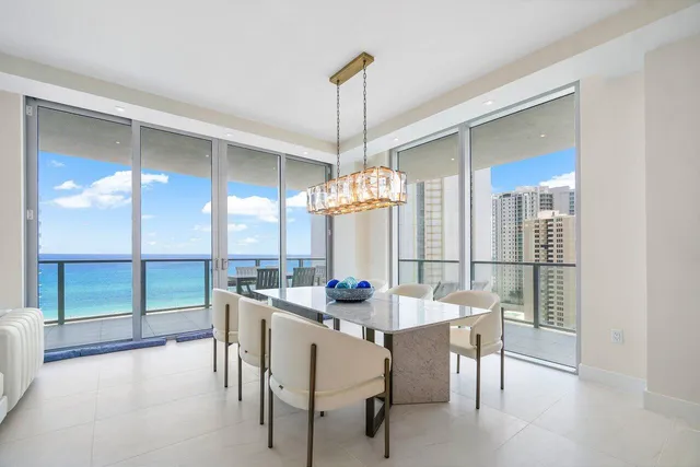 a living room with furniture wooden floor and a large window