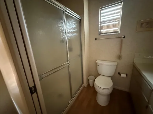 a white toilet sitting next to a sink