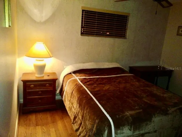a bedroom with a bed and a lamp