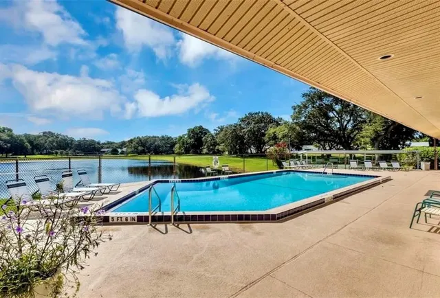 a view of a swimming pool with a lounge chair