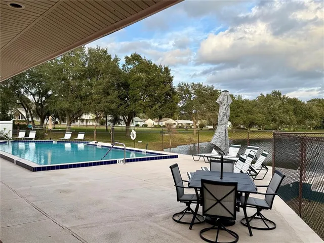 a view of swimming pool with outdoor seating and plants