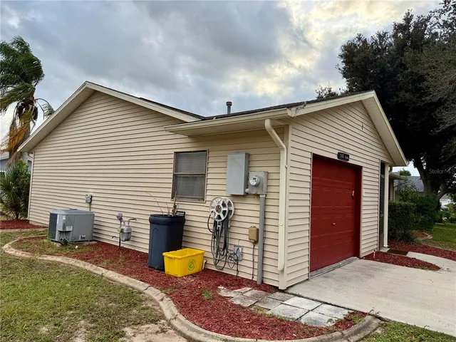 a view of a house with a patio and a yard