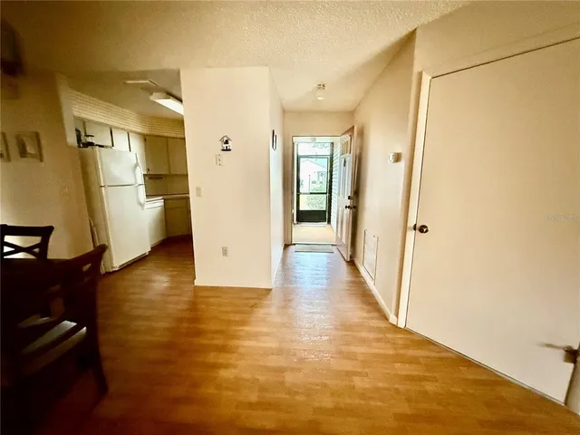 a view of a big room with wooden floor and windows
