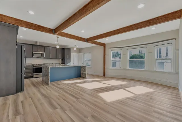 a view of kitchen with cabinets and wooden floor