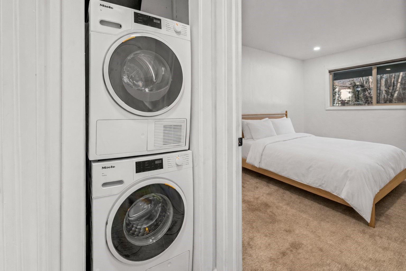 1375 Walton Creek Road, Unit 7 Steamboat Springs, CO 80487 - Photo 15 of 21 a bedroom with a bed and a washing machine