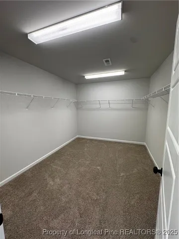 a spacious bathroom with a double vanity sink a mirror and a shower