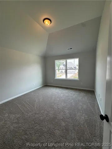 an empty room with a window and fireplace