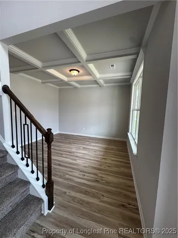 a view of hallway with wooden floor