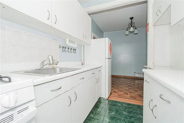 a utility room with cabinets washer and dryer