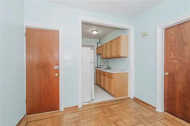 a view of an empty room with closet and a window