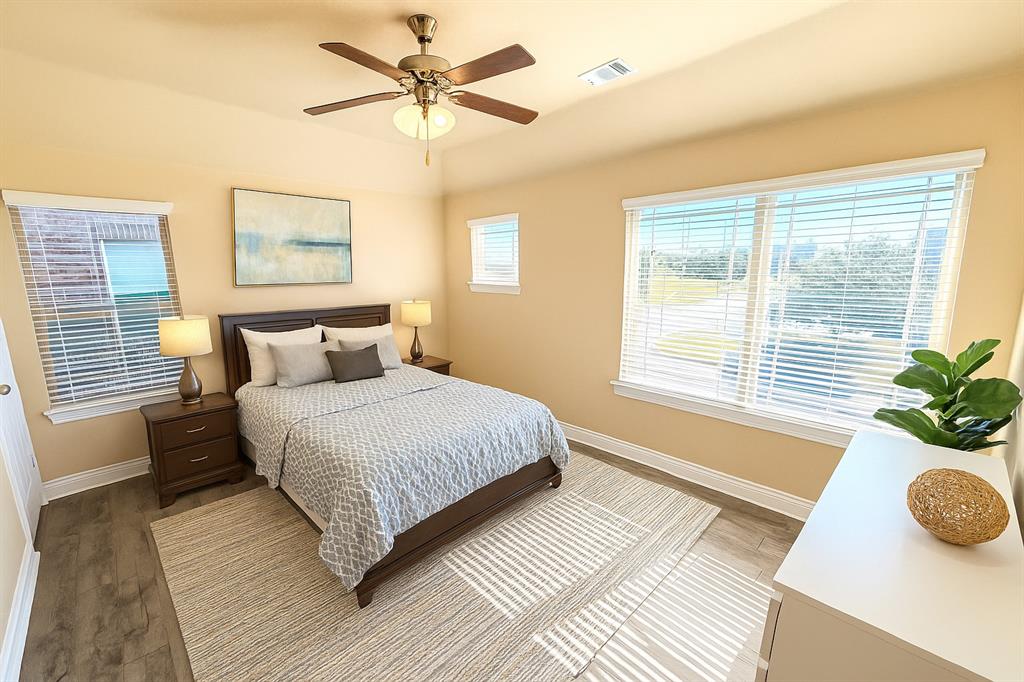 2403 Rosemary Lane Rowlett, TX 75089 - Photo 12 of 20 a bedroom with a large bed and a window