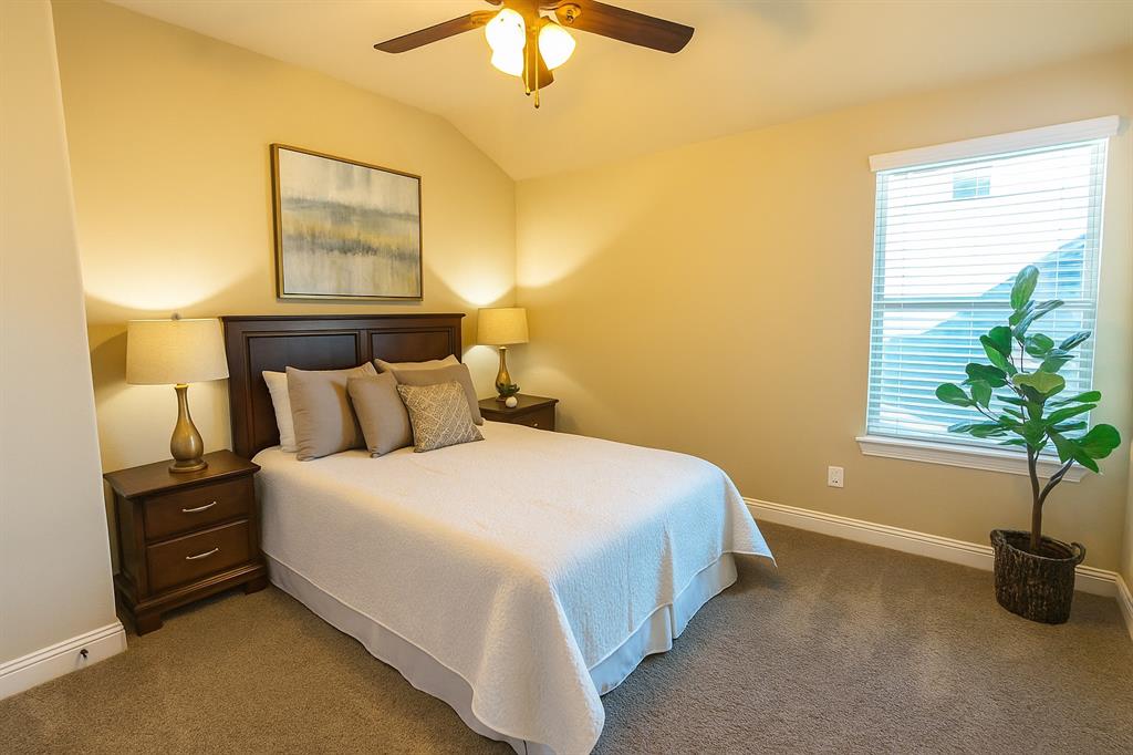 2403 Rosemary Lane Rowlett, TX 75089 - Photo 13 of 20 a bedroom with a bed and a potted plant