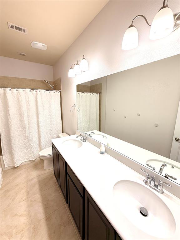 2403 Rosemary Lane Rowlett, TX 75089 - Photo 15 of 20 a bathroom with a double vanity sink and a mirror