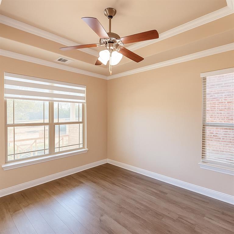 2403 Rosemary Lane Rowlett, TX 75089 - Photo 2 of 20 an empty room with wooden floor fan and windows