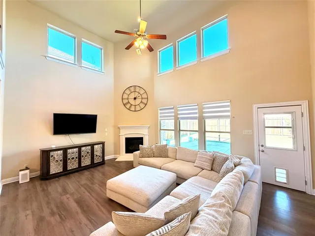 a living room with furniture a fireplace and a flat screen tv