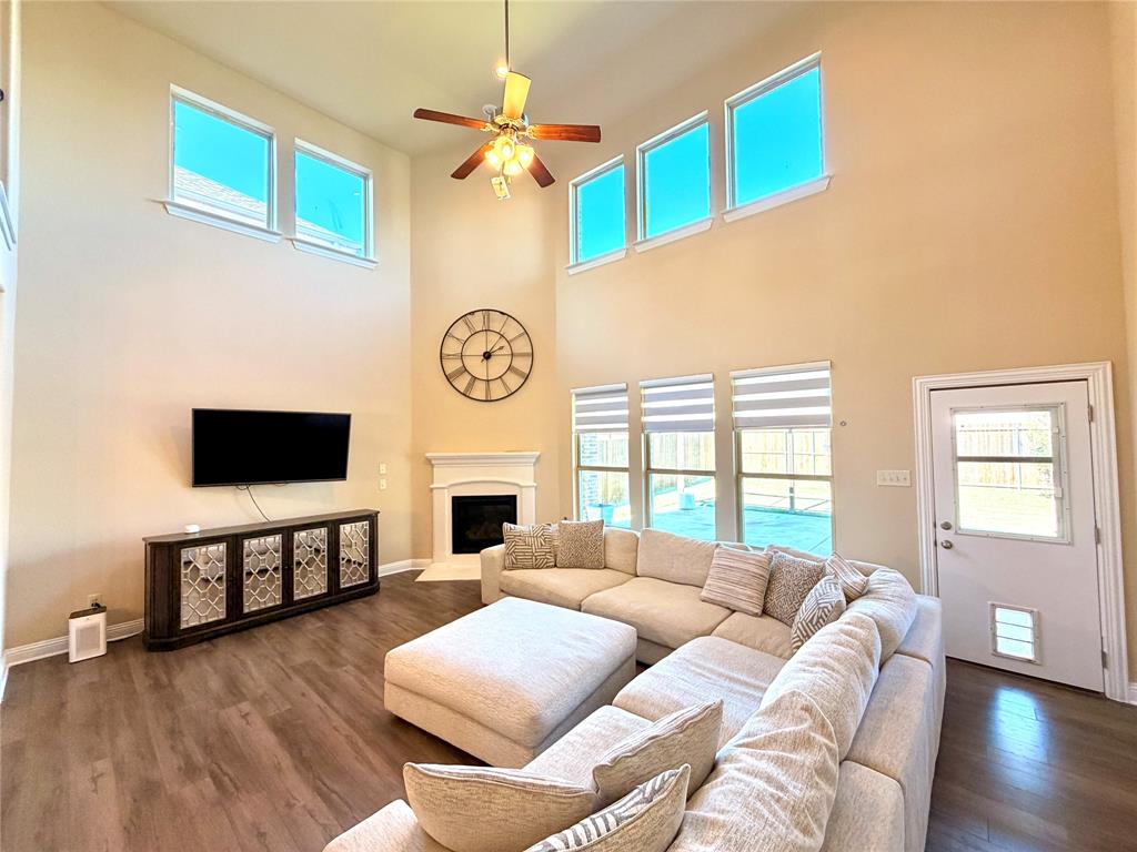 2403 Rosemary Lane Rowlett, TX 75089 - Photo 3 of 20 a living room with furniture a fireplace and a flat screen tv