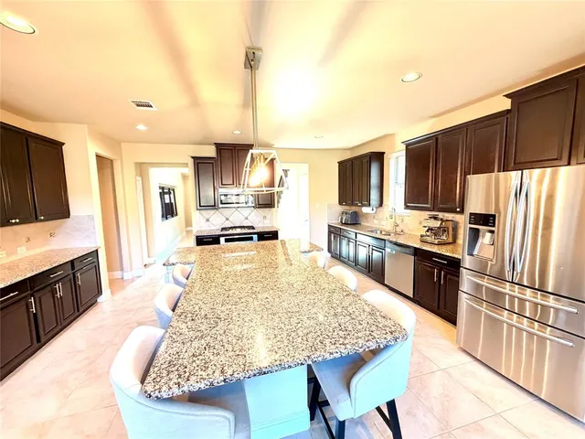 a kitchen with a stove a refrigerator and a sink