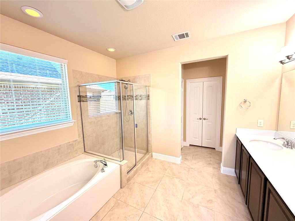 2403 Rosemary Lane Rowlett, TX 75089 - Photo 7 of 20 a spacious bathroom with a tub sink and shower