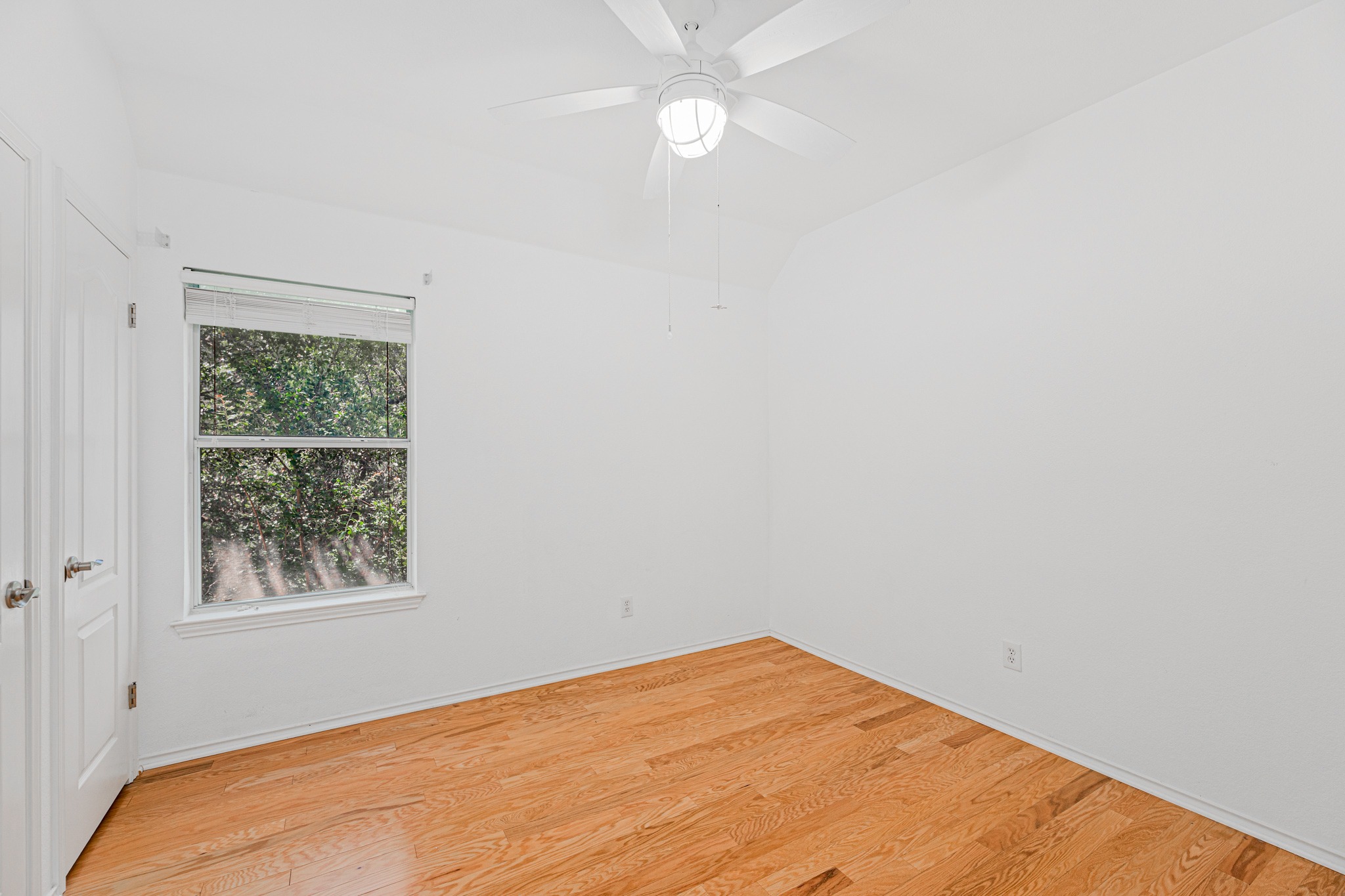304 River Down Road Georgetown, TX 78628 - Photo 17 of 22 Bright room featuring wood-finish flooring, a double-door closet, a single window, and a ceiling fan with integrated lighting