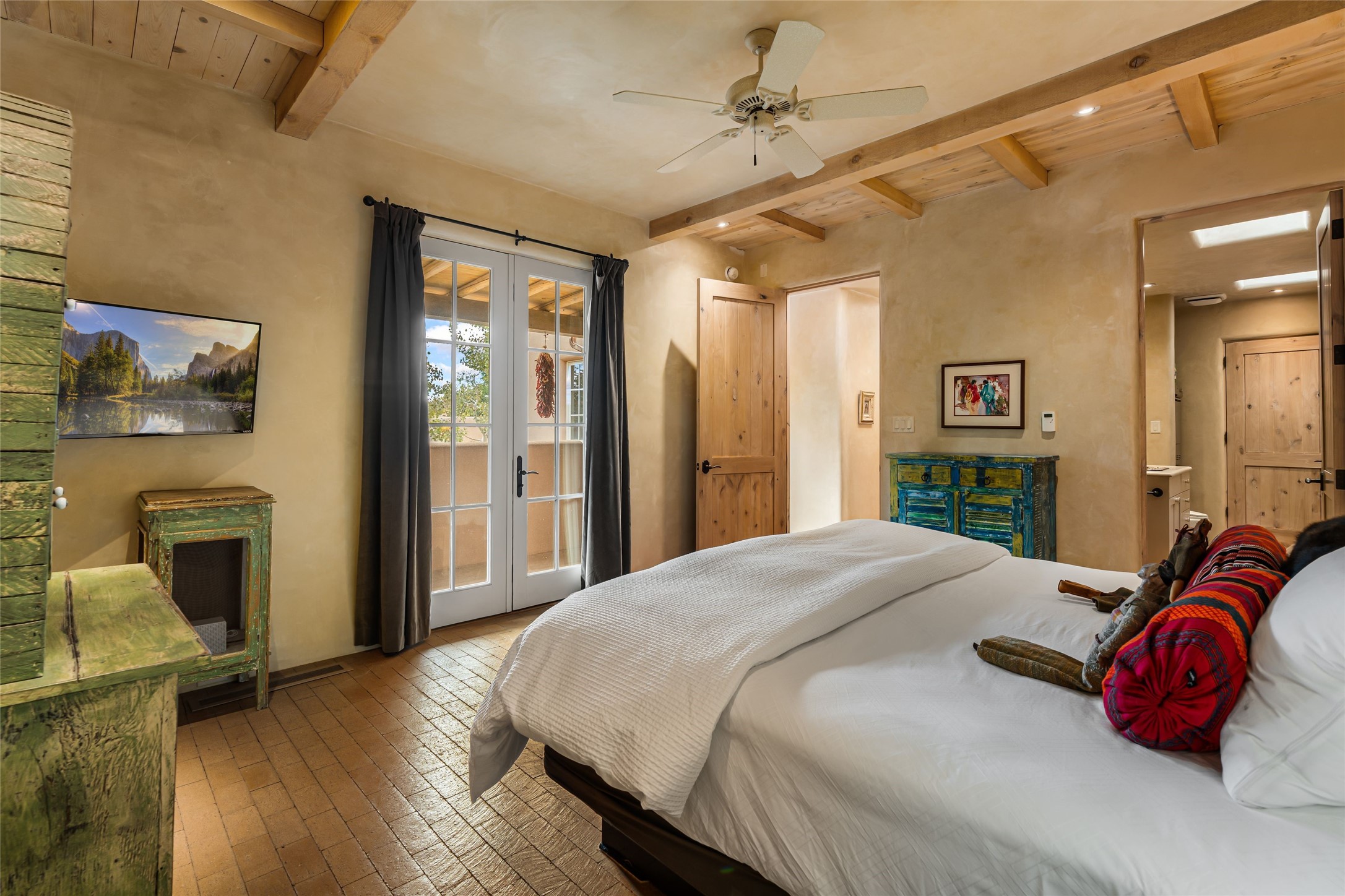1 Cerro Gordo Road, Unit B Santa Fe, NM 87501 - Photo 3 of 25 Spaciou s Primary bedroom suite with French doors outside.
