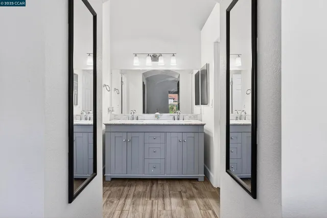 a bathroom with a double vanity sink and mirror