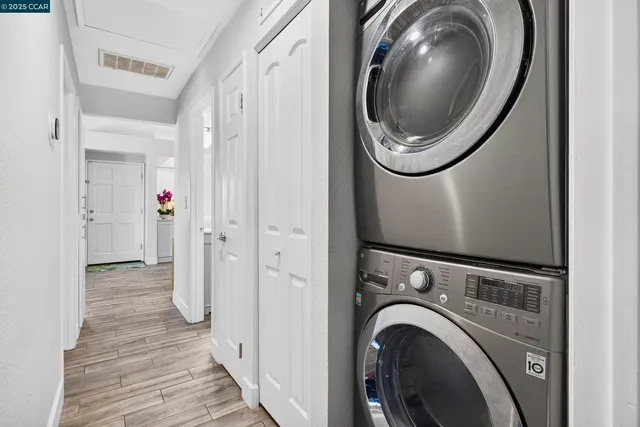 a view of a hallway with washer and dryer
