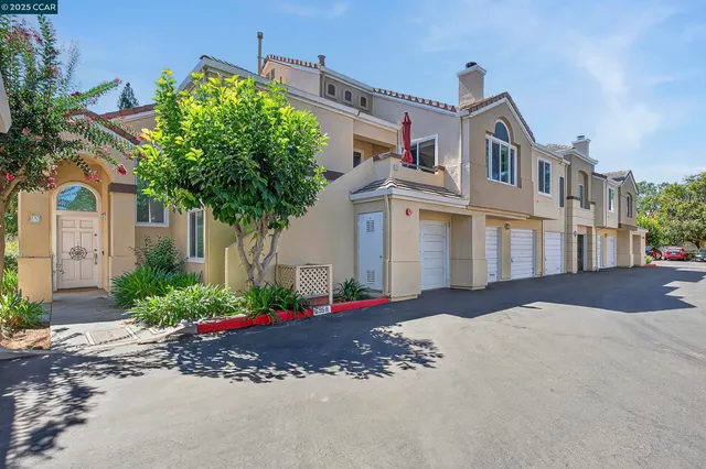 a front view of a house with a yard and a garage