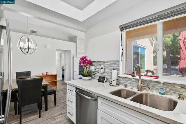 a kitchen with a sink and a refrigerator
