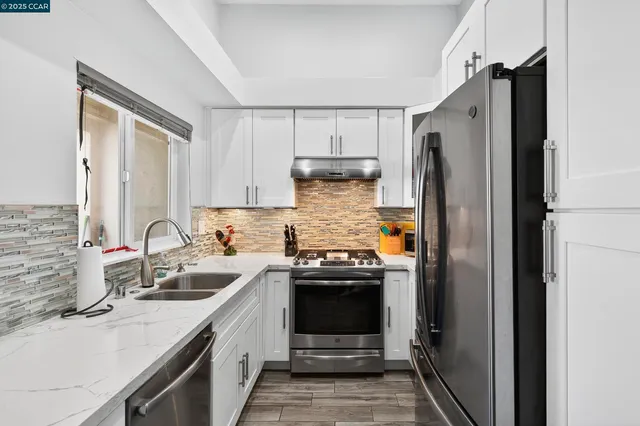a kitchen with a sink stove and refrigerator