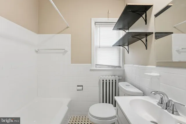 a white toilet sitting next to a bathroom sink