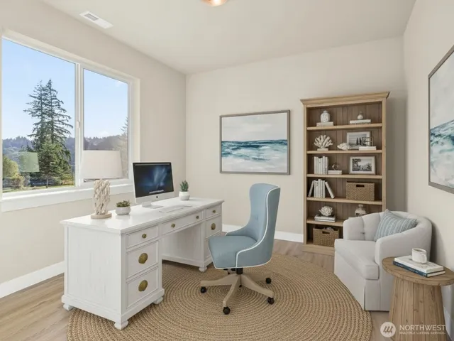 a view of a workspace with furniture and a window